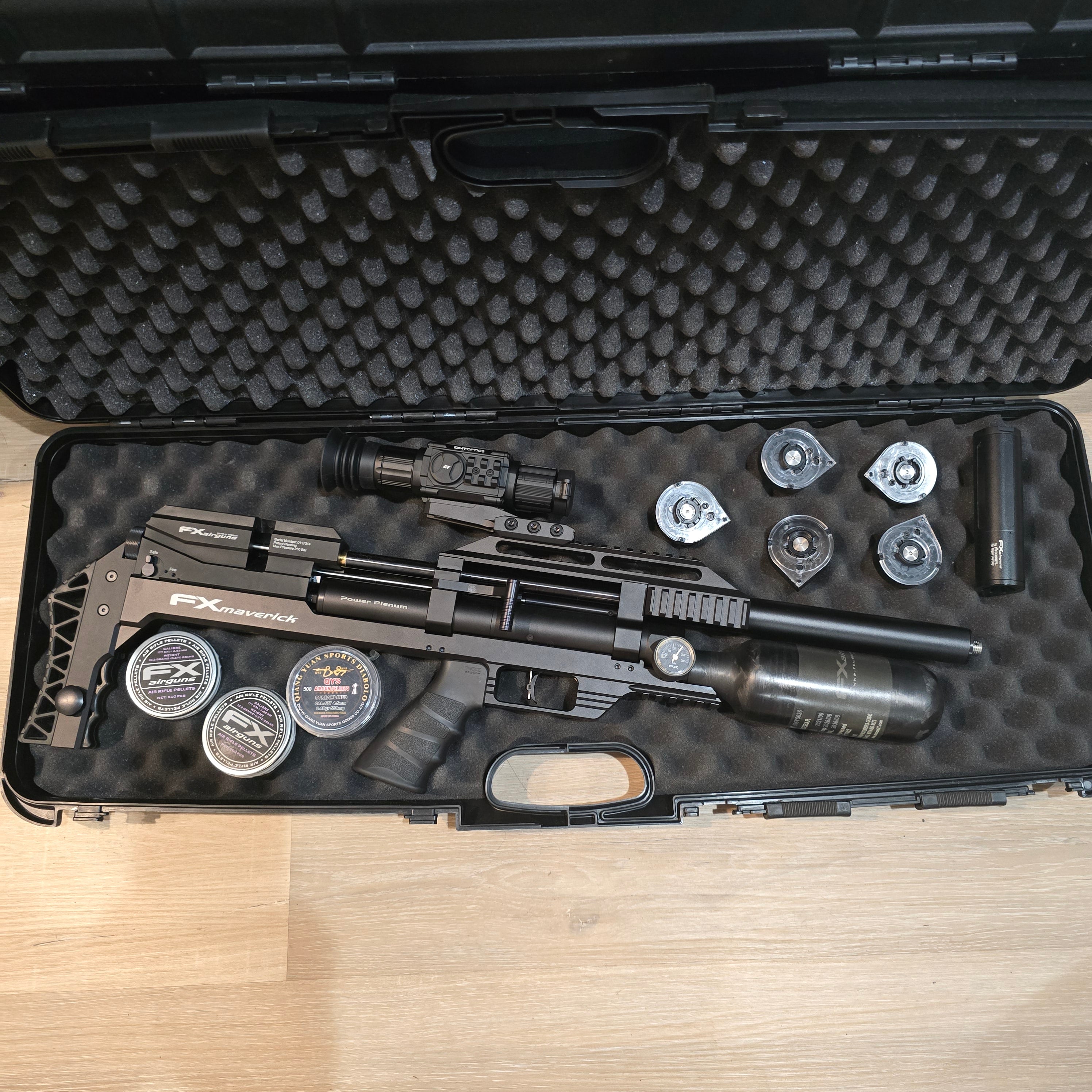 Black airgun in a foam-lined case on a wooden surface