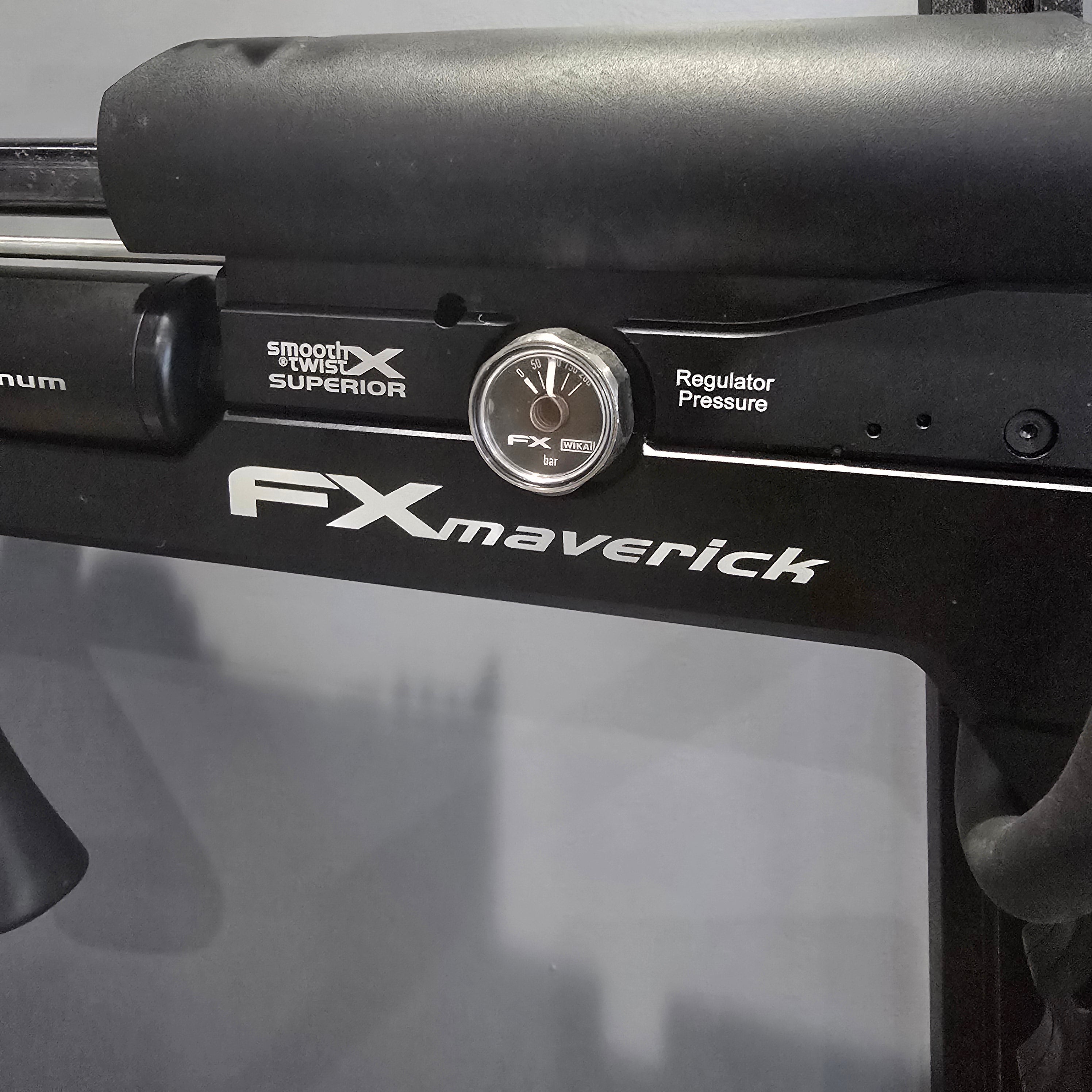 Close-up of FX Maverick air rifle with visible branding and features.